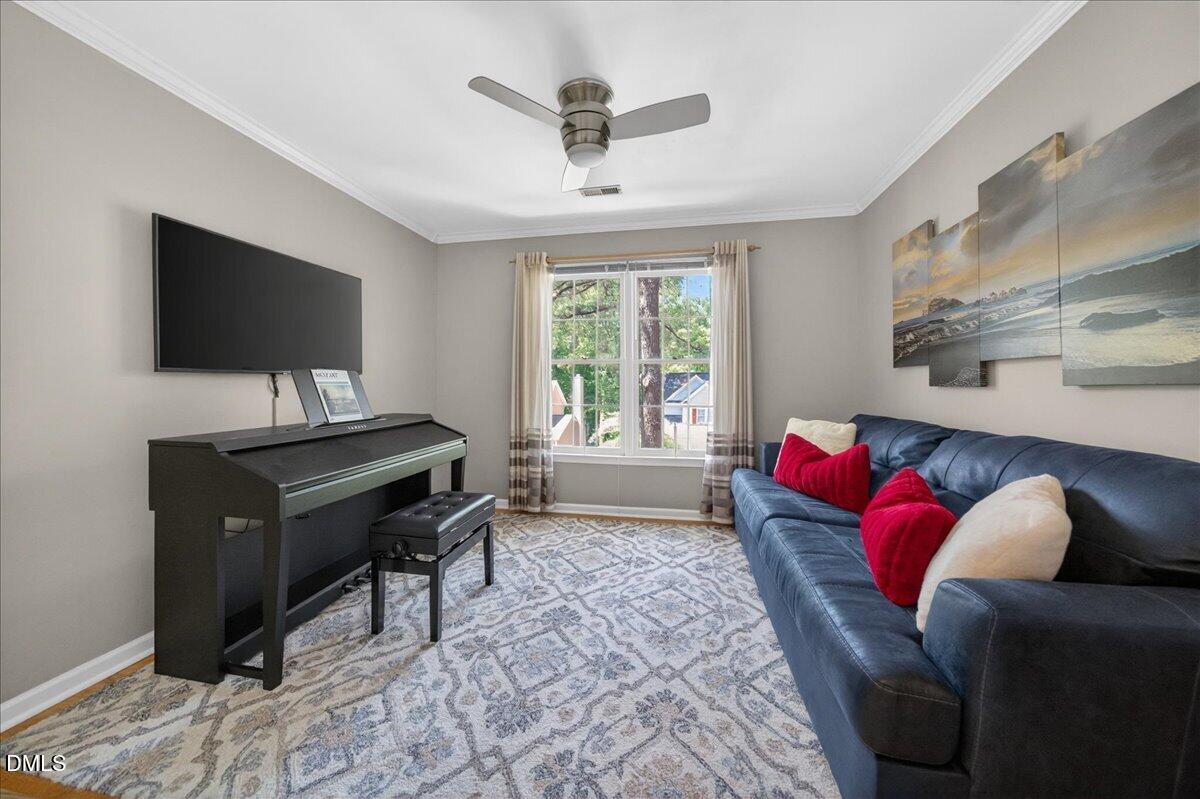 9536 Bells Valley Drive Raleigh, NC 27617 - Photo 19 of 39 a living room with furniture and a flat screen tv