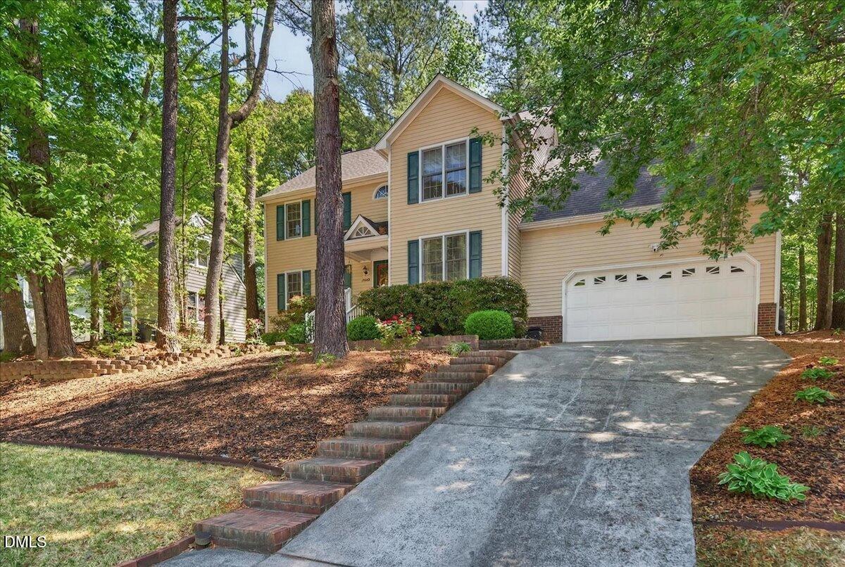 9536 Bells Valley Drive Raleigh, NC 27617 - Photo 2 of 39 a front view of a house with a yard and a garage