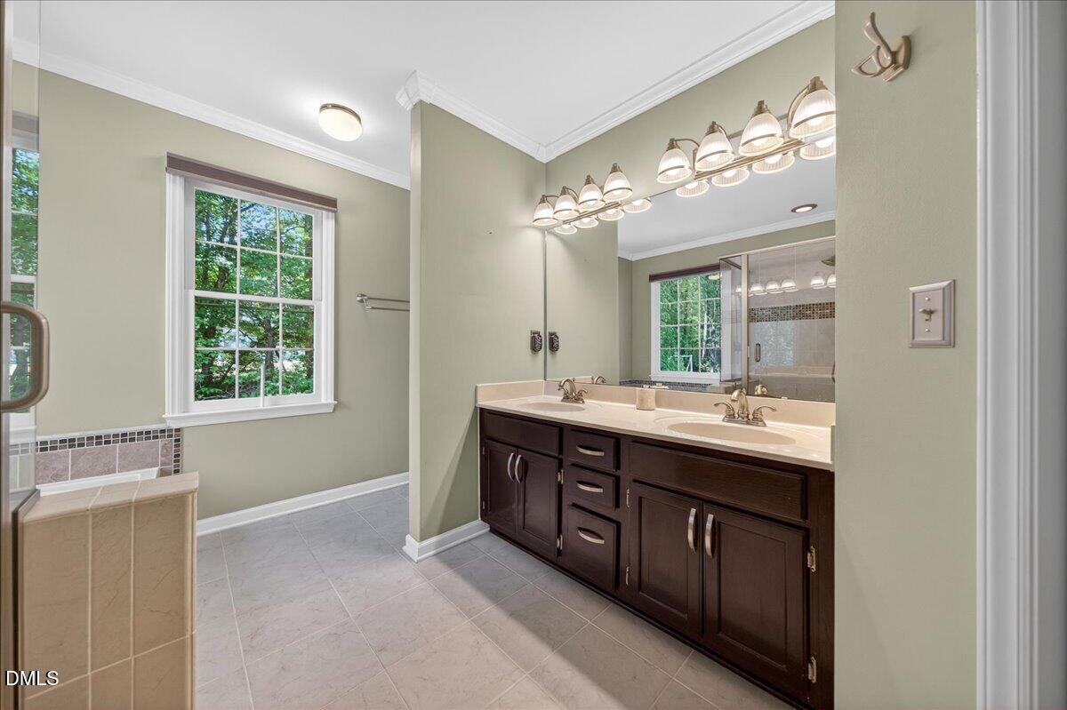 9536 Bells Valley Drive Raleigh, NC 27617 - Photo 25 of 39 a bathroom with a double vanity sink and a mirror