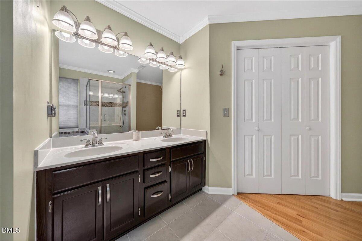 9536 Bells Valley Drive Raleigh, NC 27617 - Photo 27 of 39 a bathroom with a double vanity sink and a mirror