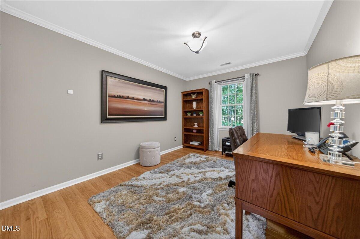9536 Bells Valley Drive Raleigh, NC 27617 - Photo 28 of 39 a bedroom with a bed and a flat screen tv