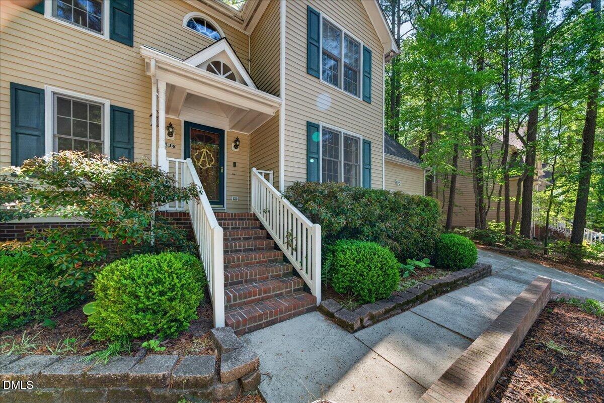 9536 Bells Valley Drive Raleigh, NC 27617 - Photo 3 of 39 a view of a house with entryway and plants