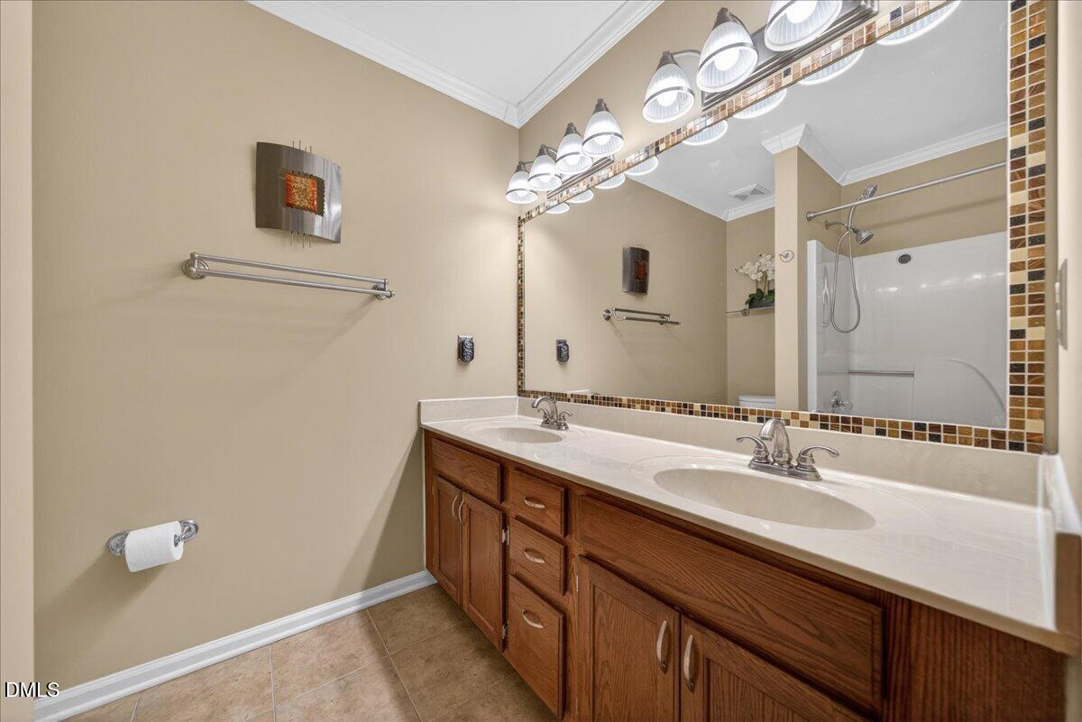 9536 Bells Valley Drive Raleigh, NC 27617 - Photo 32 of 39 a bathroom with a double vanity sink and a mirror