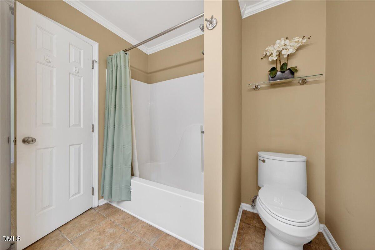 9536 Bells Valley Drive Raleigh, NC 27617 - Photo 33 of 39 a bathroom with a toilet a sink and bathtub