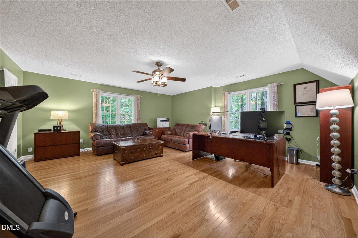 9536 Bells Valley Drive Raleigh, NC 27617 - Photo 34 of 39 a living room with furniture and a flat screen tv