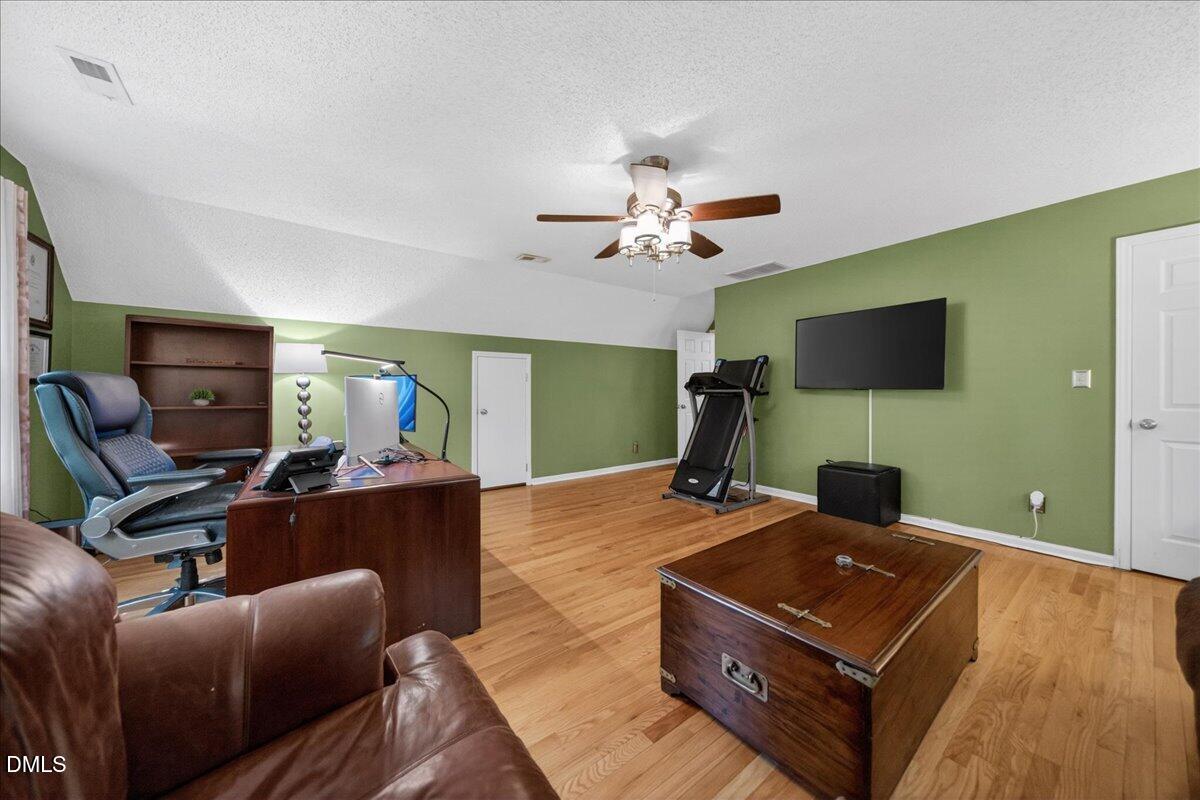 9536 Bells Valley Drive Raleigh, NC 27617 - Photo 35 of 39 a living room with furniture and a flat screen tv