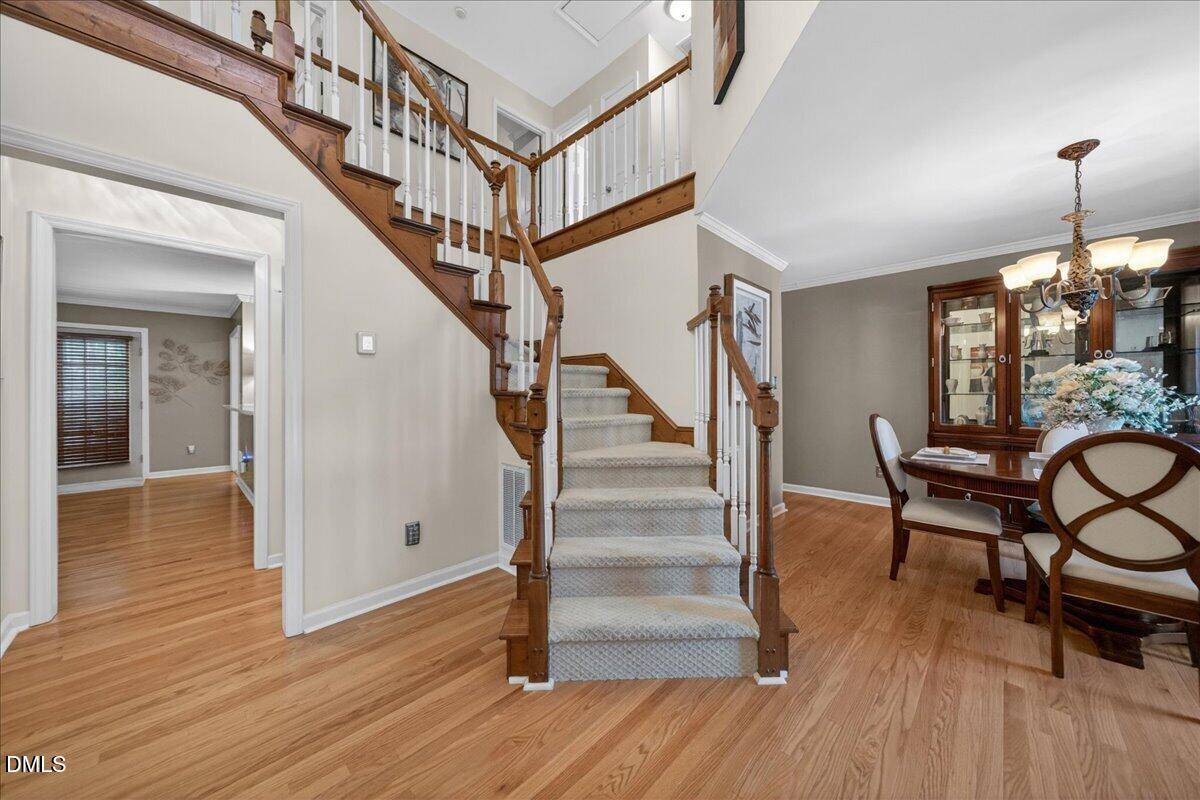 9536 Bells Valley Drive Raleigh, NC 27617 - Photo 5 of 39 a view of entryway dining room and hall with wooden floor