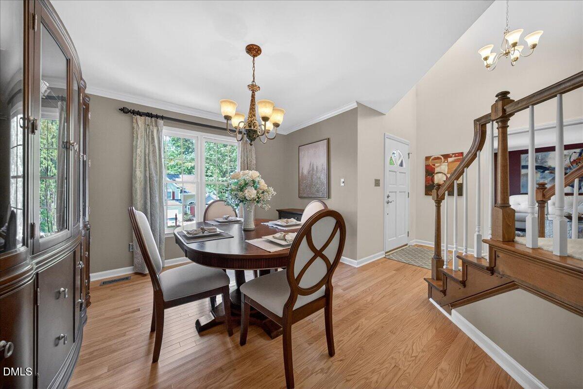 9536 Bells Valley Drive Raleigh, NC 27617 - Photo 6 of 39 a view of a dining room with furniture window and wooden floor