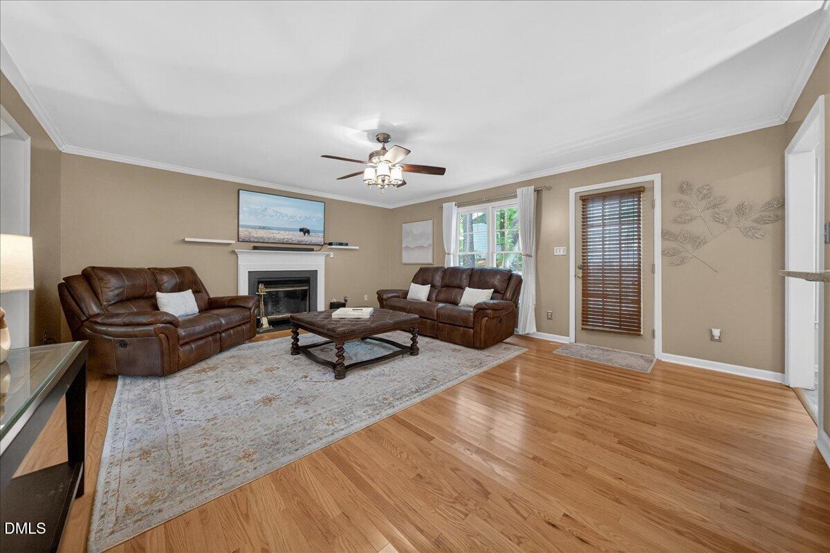 9536 Bells Valley Drive Raleigh, NC 27617 - Photo 9 of 39 a living room with furniture and a chandelier