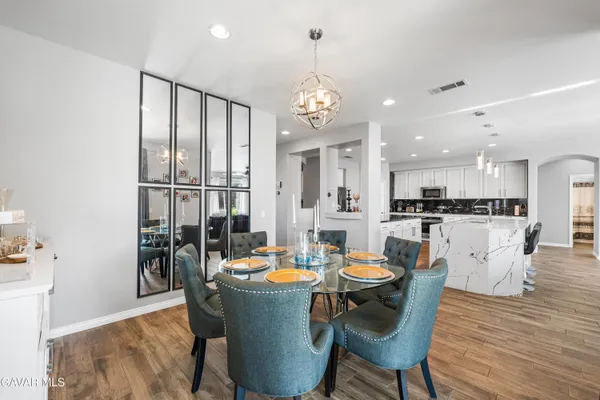 a large kitchen with a table and chairs