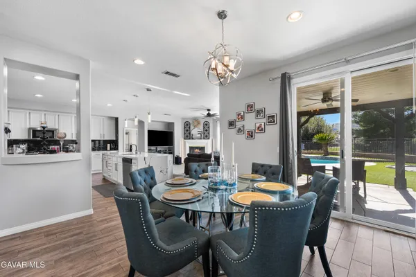 a kitchen with stainless steel appliances granite countertop a refrigerator a stove and a sink