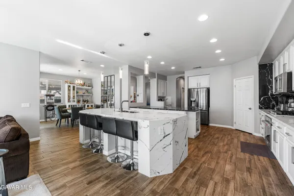 a spacious bedroom with a bed and a chandelier