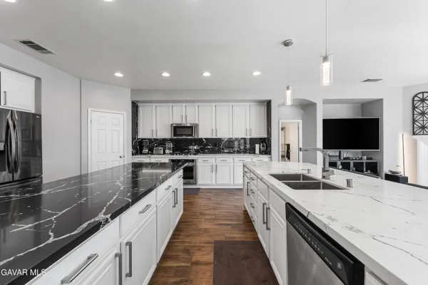 a bathroom with a granite countertop sink and a mirror