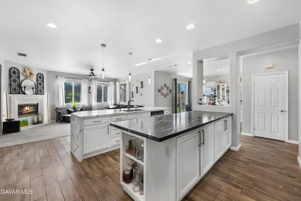 a patio with a table and chairs and a barbeque