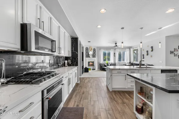 a living room with fireplace furniture and a flat screen tv