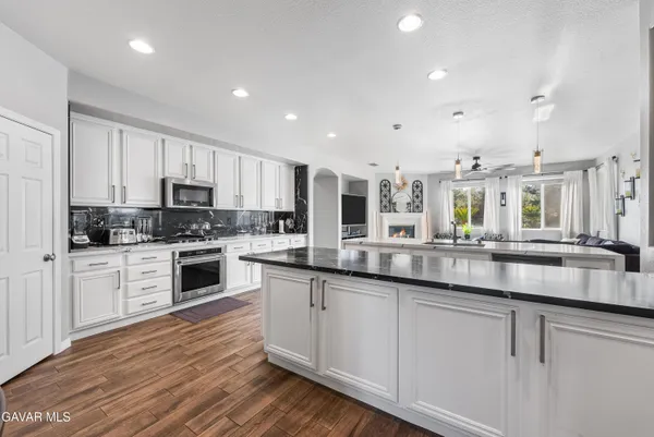 a living room with furniture a ceiling fan and a rug