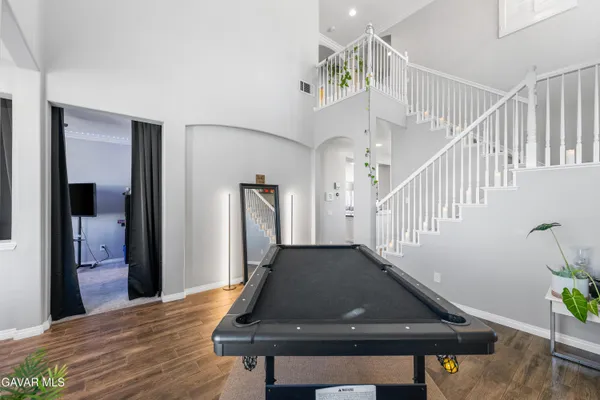 a living room with furniture a flat screen tv and a large window