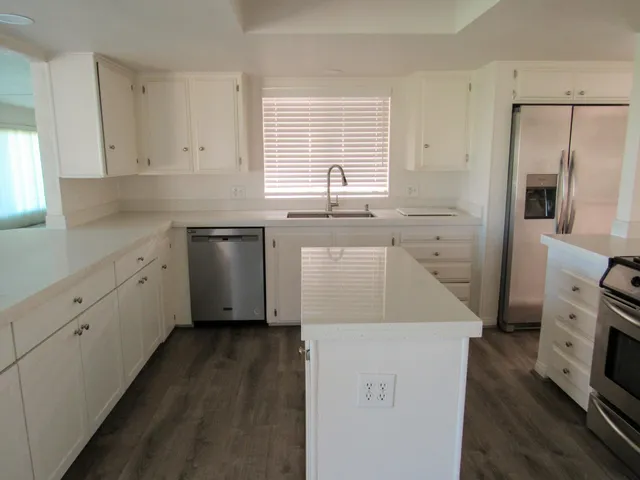 a kitchen with a sink stove and refrigerator