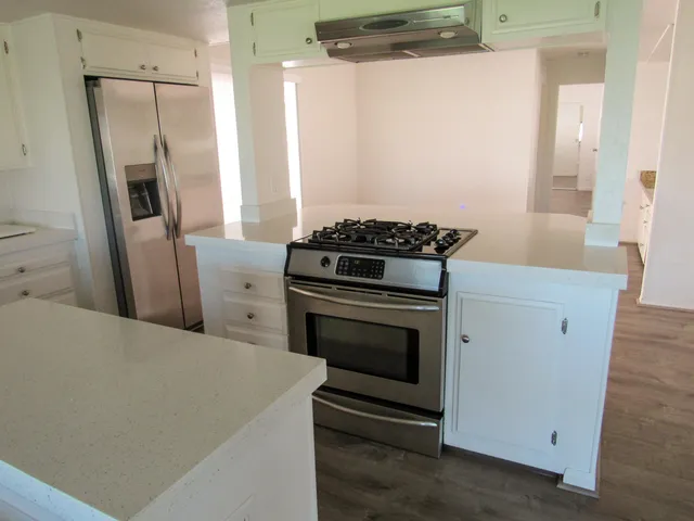 a kitchen with a stove microwave and a refrigerator