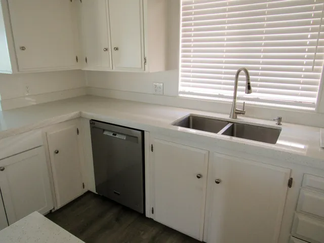 a kitchen with a sink and cabinets