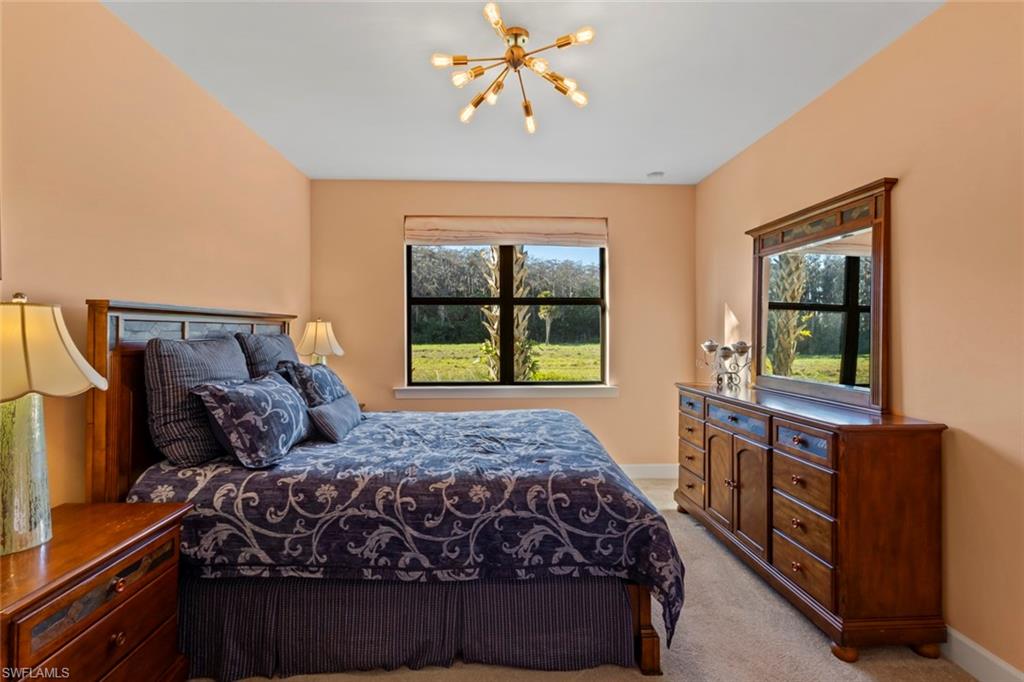 5701 Mayflower Way, Unit 1302 Ave Maria, FL 34142 - Photo 15 of 32 a bedroom with a bed and window