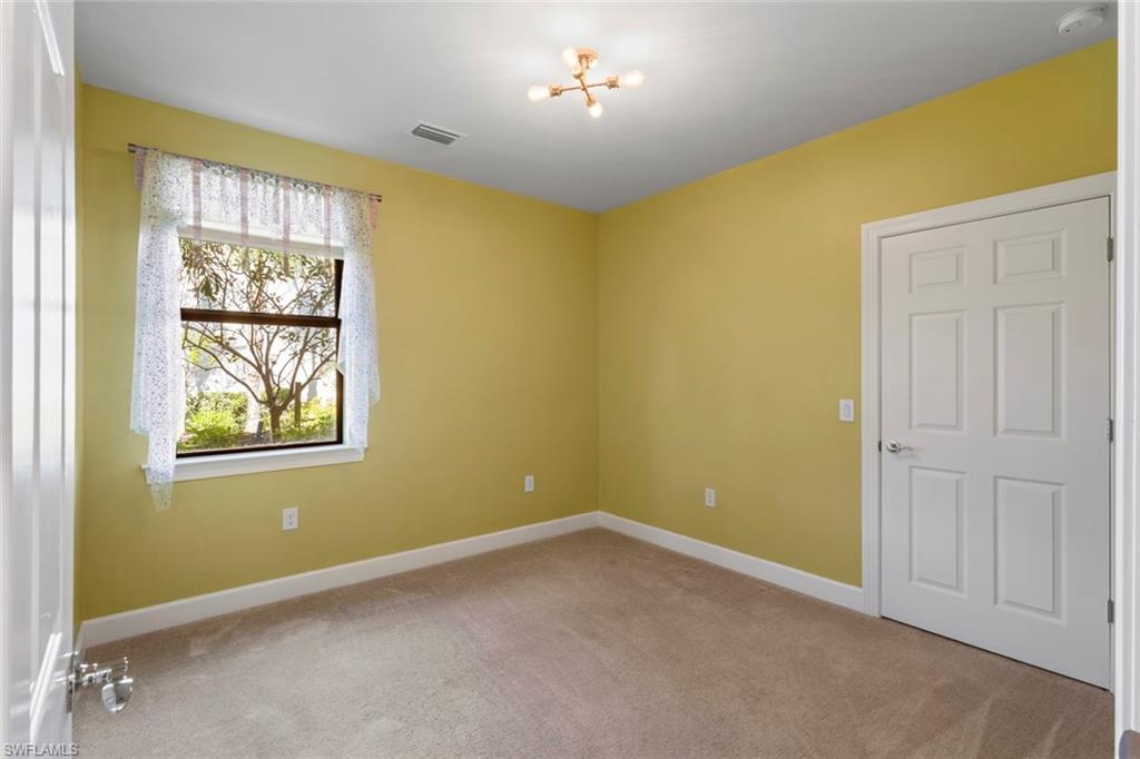 5701 Mayflower Way, Unit 1302 Ave Maria, FL 34142 - Photo 19 of 32 an empty room with windows