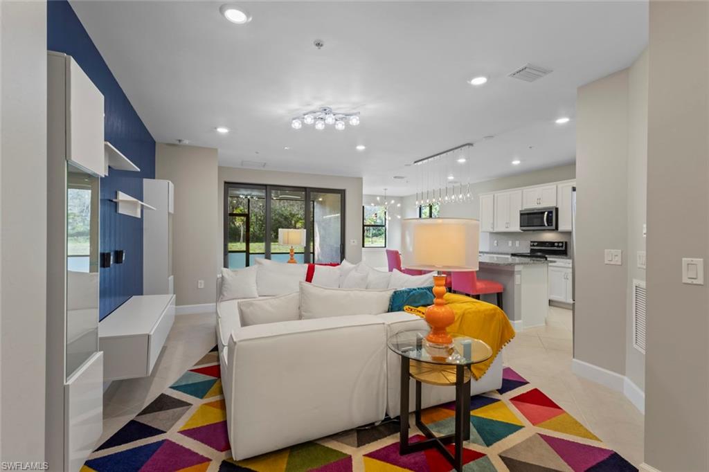 5701 Mayflower Way, Unit 1302 Ave Maria, FL 34142 - Photo 2 of 32 a living room with furniture and kitchen view