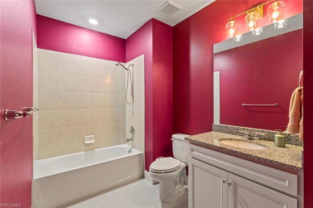 5701 Mayflower Way, Unit 1302 Ave Maria, FL 34142 - Photo 21 of 32 a bathroom with a granite countertop toilet sink shower and bathtub