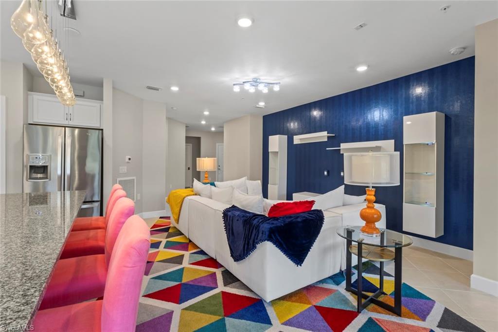 5701 Mayflower Way, Unit 1302 Ave Maria, FL 34142 - Photo 6 of 32 a bedroom with furniture and a lamp