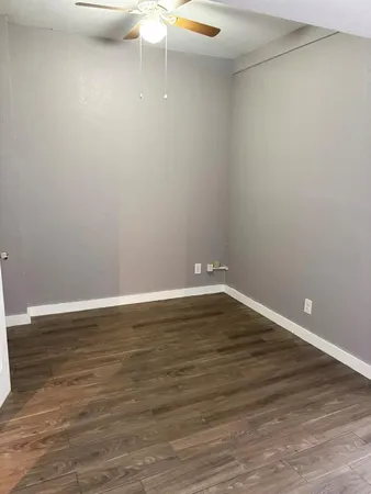 a view of a room with wooden floor