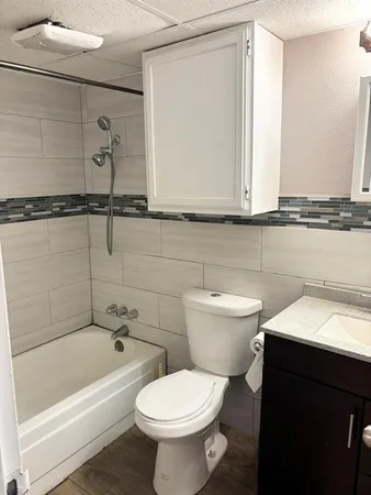 a bathroom with a sink a toilet and bathtub