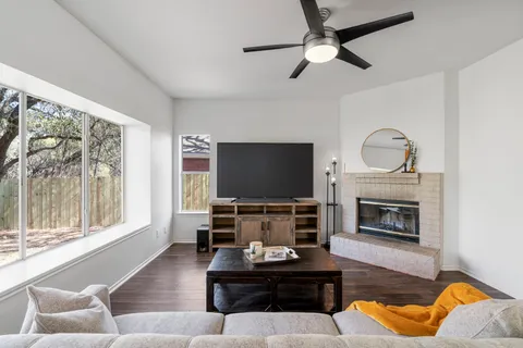a living room with furniture a fireplace and a flat screen tv