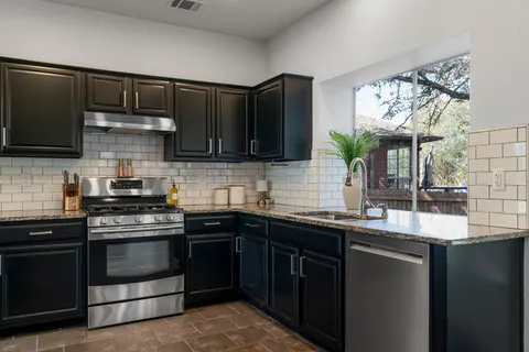 a kitchen with a sink stove and microwave