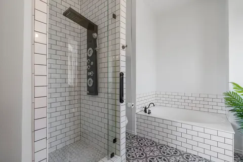 a bathroom with a bathtub and shower