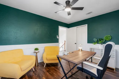 a view of a dining room with furniture and a potted plant