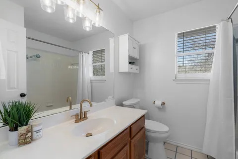 a bathroom with a sink toilet and shower