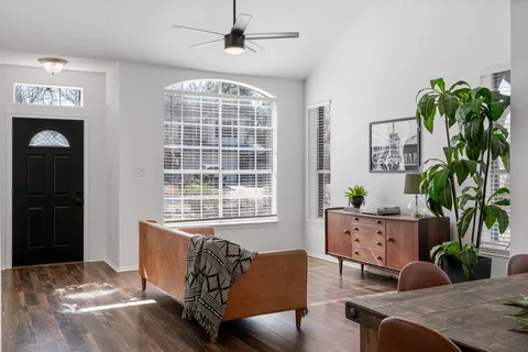 a living room with furniture and a potted plant