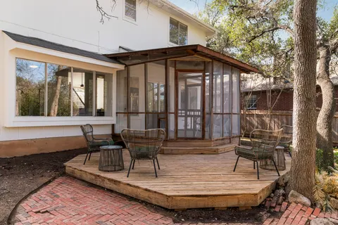 a view of wooden house with outdoor seating
