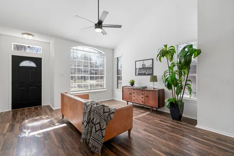 a living room with furniture and a potted plant