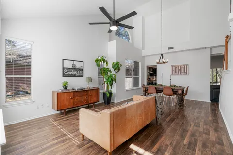 a living room with furniture and a wooden floor