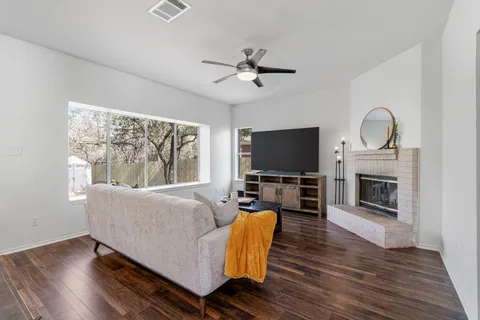 a living room with furniture fireplace and flat screen tv