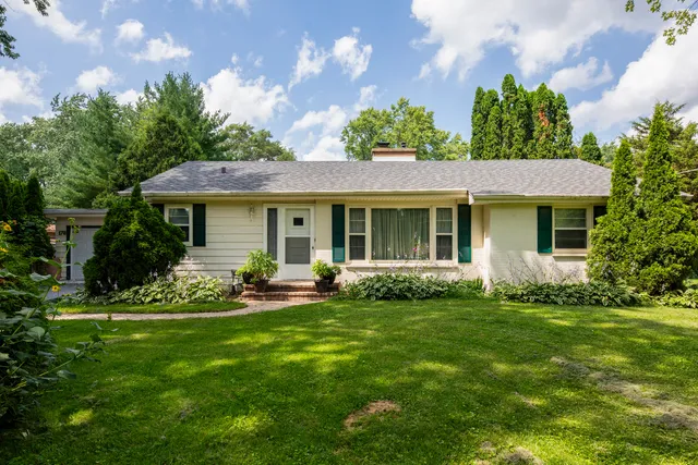 a front view of a house with a garden and porch