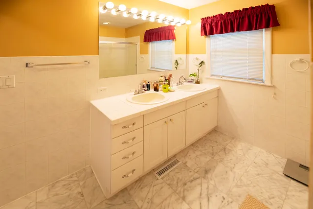 a spacious bathroom with a double vanity sink mirror and