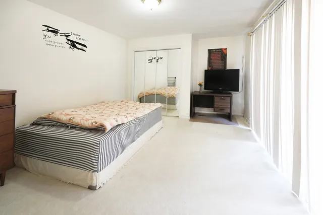 a bedroom with a bed and a television