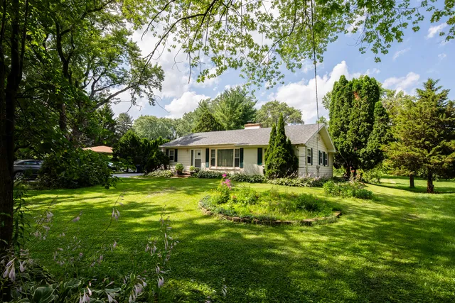 a backyard of a house with table and chairs