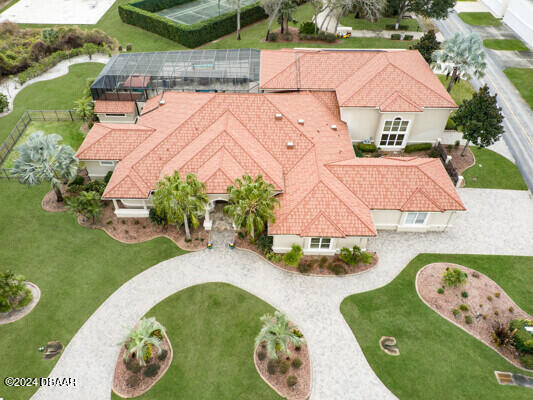 an aerial view of a house with garden space and swimming pool