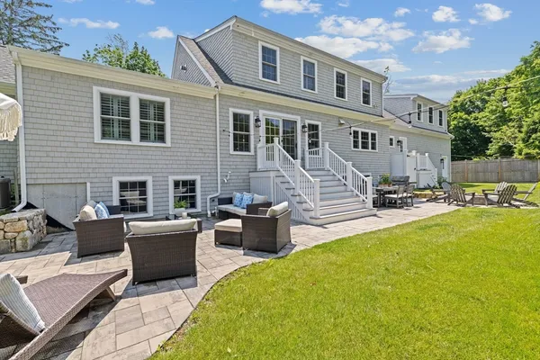 a view of a house with swimming pool and furniture