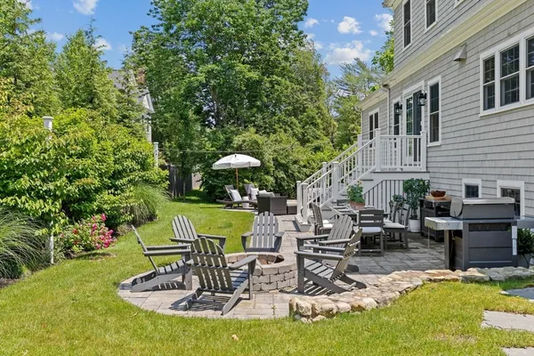 a view of a chairs and table in backyard