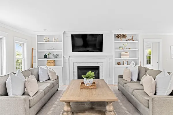 a living room with furniture fireplace and flat screen