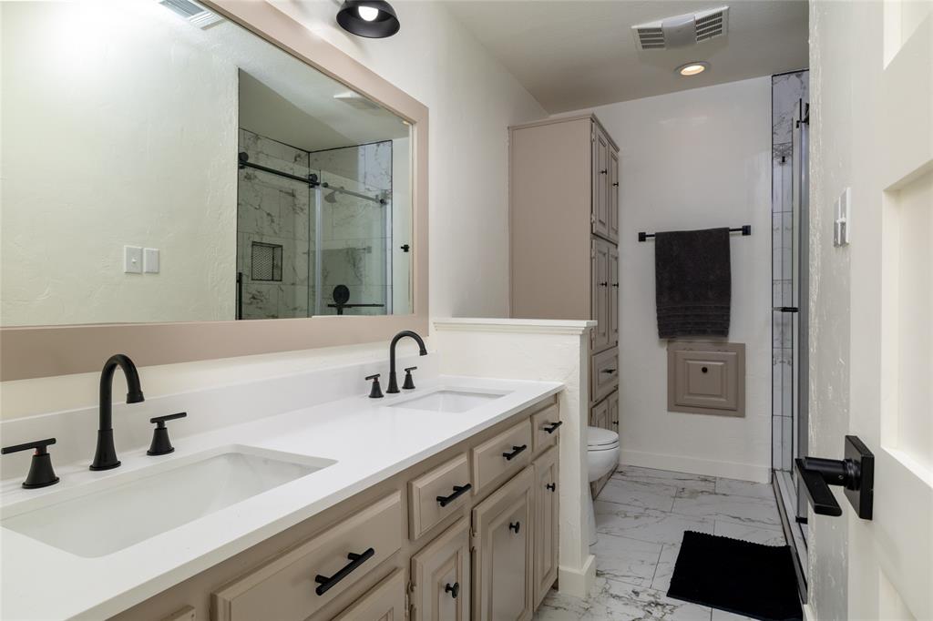 8948 David Fort Road Argyle, TX 76226 - Photo 31 of 39 Double vanity with white countertops and matte black fixtures